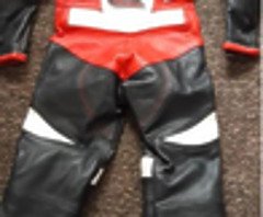 Kids all in one motorbike leathers never worn, and shark helmet