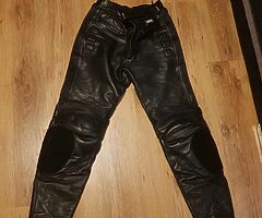 2 pairs leather motorcycle bottoms.