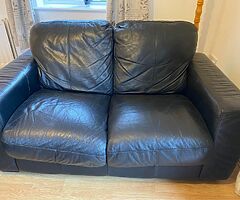 2 black leather sofas