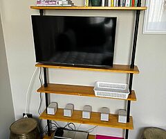 Shelving unit with with wooden shelves and industrial piping. - Image 3/5